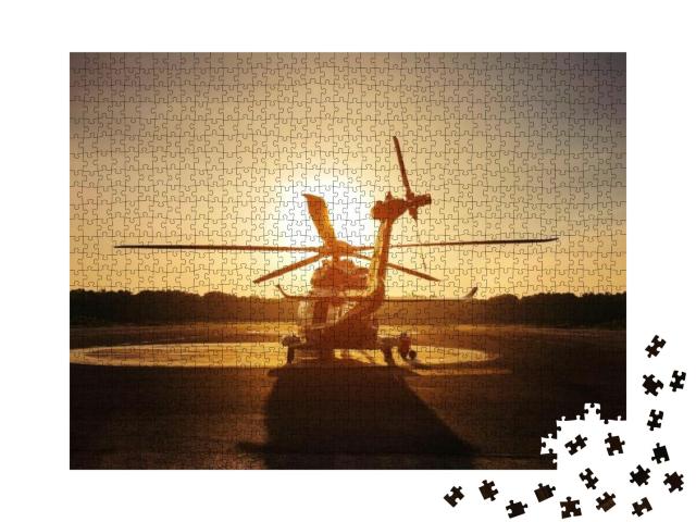 Puzzle 1000 Teile „Hubschrauber auf dem Landeplatz im Sonnenuntergang“