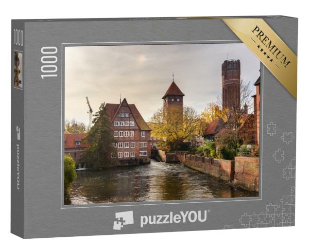 Puzzle 1000 Teile „Ratsmühle oder alte Wassermühle und Wasserturm an der Ilmenau, Lüneburg“