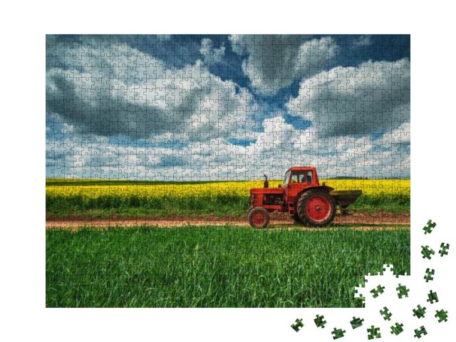 Puzzle 1000 Teile „Roter Traktor mit Anhänger vor einem Rapsfeld, Oxfordshire“
