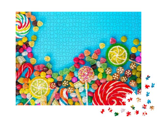 Puzzle 1000 Teile „Bunte Bonbons, Cakepops, Smarties und Gummibärchen auf blauem Hintergrund“