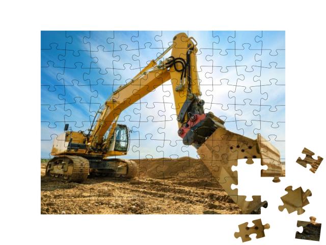 Puzzle 100 Teile „Großer Bagger auf neuer Baustelle vor dem blauen Himmel“