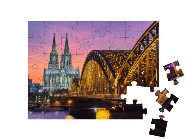 Puzzle 48 Teile „Kölner Dom und Hohenzollernbrücke bei Sonnenuntergang“